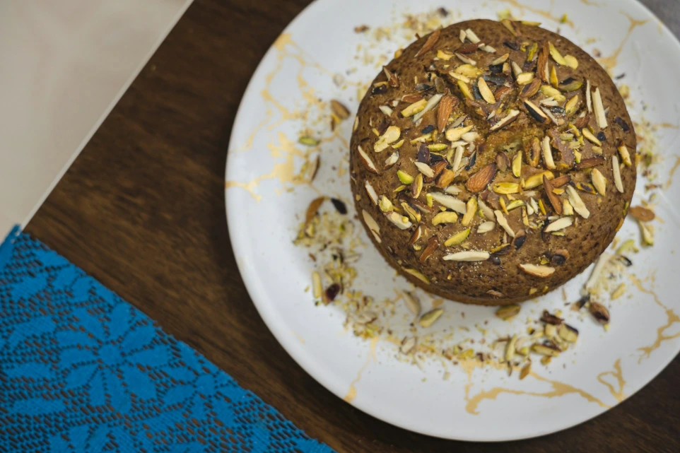 A plate with a cake on it sitting on a table